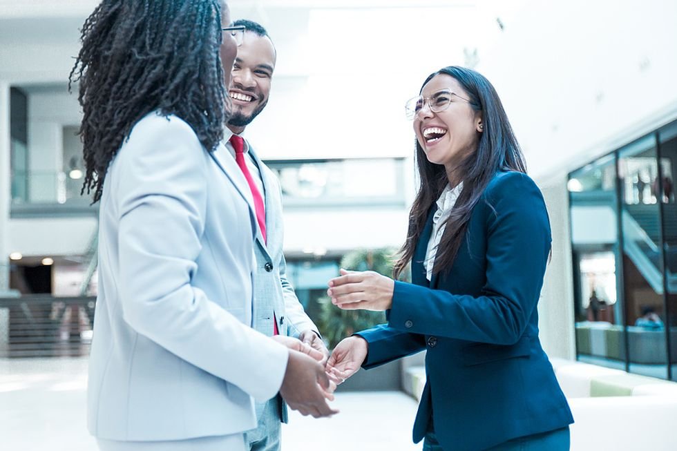 Professionals smile at a networking event