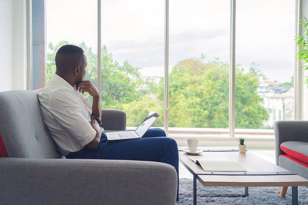 Man on laptop thinks/wonders what his workplace persona is