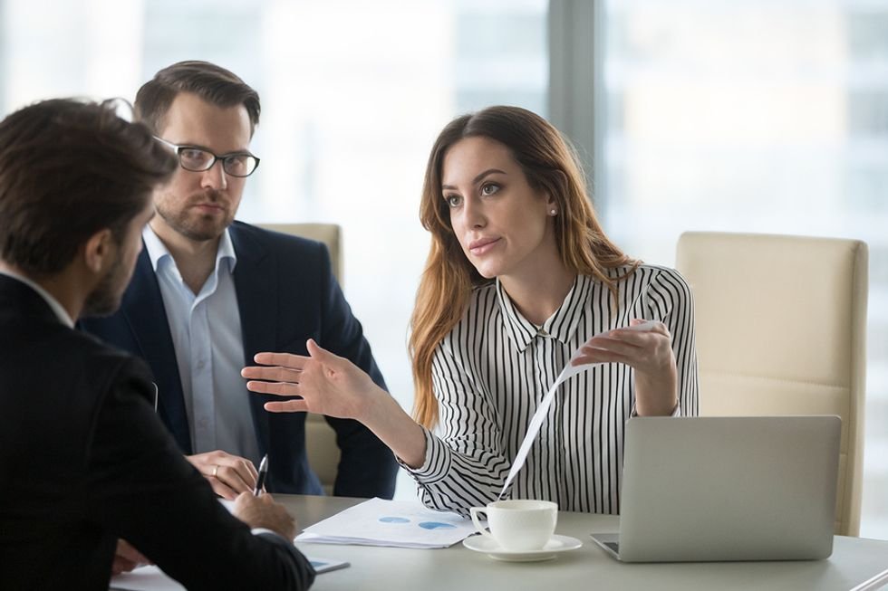 Female leader tackles conflicts at work during a meeting