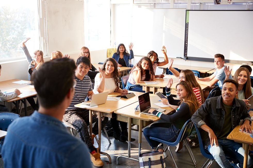 Student teacher asks the class a question during a lecture