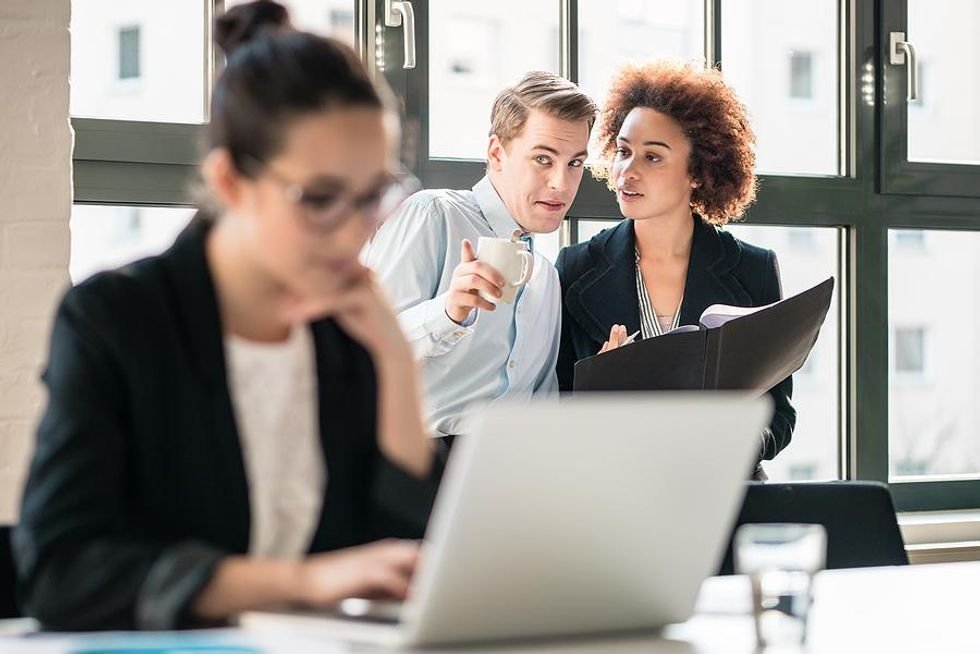 Woman deals with gossiping coworkers in a toxic work environment